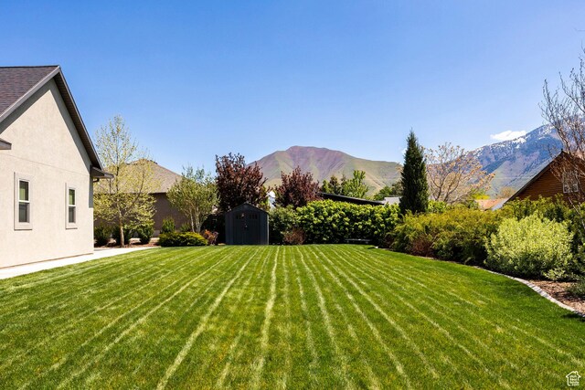 65 W Carnesecca Ct N, Mapleton, UT 84664 - view of yard with a storage unit, a mountain view, and an outbuilding