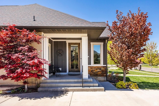 65 W Carnesecca Ct N, Mapleton, UT 84664 - property entrance featuring covered porch, a shingled roof, and stone siding