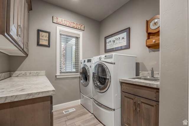 65 W Carnesecca Ct N, Mapleton, UT 84664 - laundry area with light wood finished floors, visible vents, a sink, washer and clothes dryer, and cabinet space