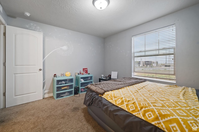 bedroom featuring a textured ceiling and carpet flooring