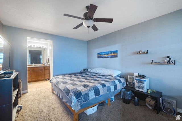bedroom with light colored carpet, connected bathroom, and ceiling fan