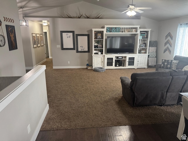 living room featuring ceiling fan, lofted ceiling, baseboards, and wood finished floors
