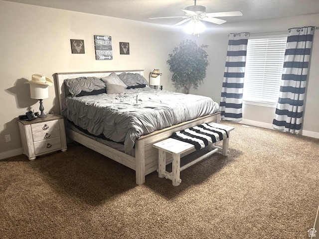 carpeted bedroom with baseboards and a ceiling fan