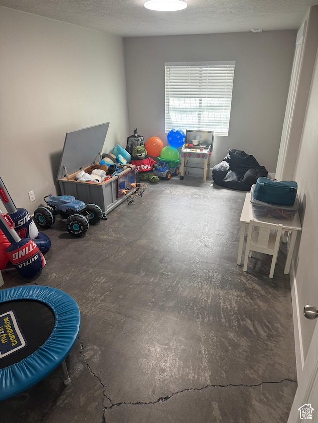 rec room featuring a textured ceiling