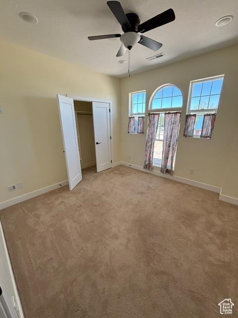 2577 W 5300 N Unit 11, Cedar City, UT 84721 - unfurnished bedroom featuring baseboards, light colored carpet, and ceiling fan