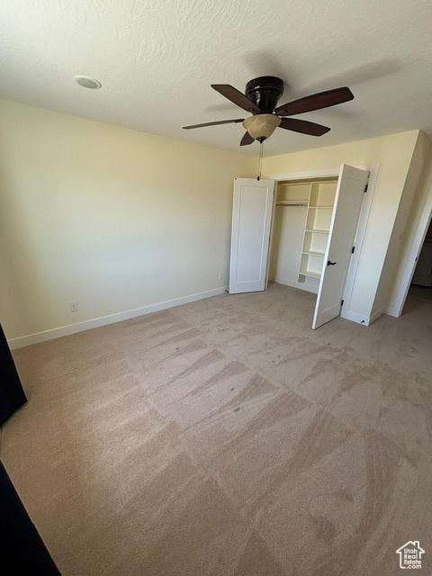 2577 W 5300 N Unit 11, Cedar City, UT 84721 - unfurnished bedroom with baseboards, a closet, light carpet, ceiling fan, and a textured ceiling