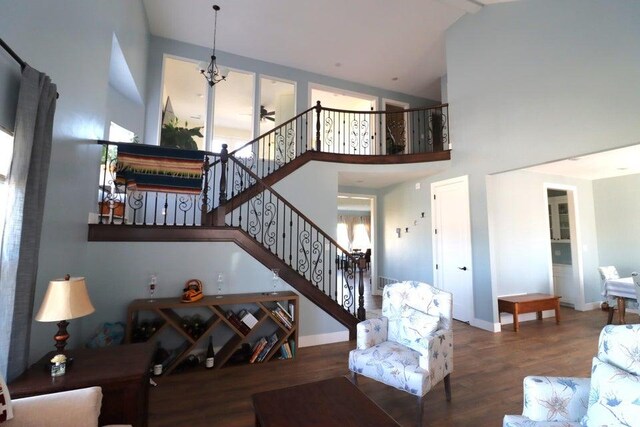 2577 W 5300 N Unit 11, Cedar City, UT 84721 - living room with wood finished floors, stairway, high vaulted ceiling, baseboards, and ceiling fan