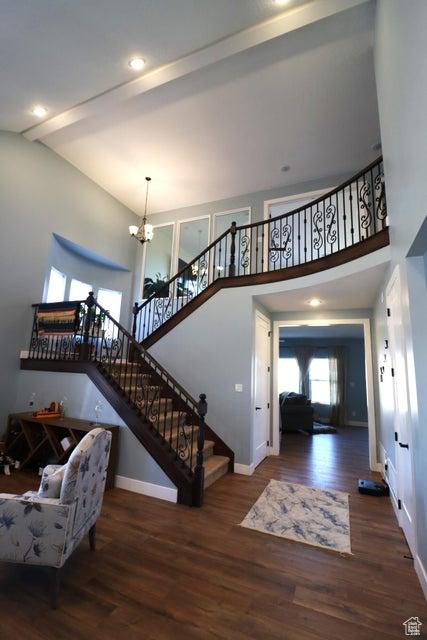 2577 W 5300 N Unit 11, Cedar City, UT 84721 - living room with a chandelier, wood finished floors, stairway, baseboards, and a high ceiling
