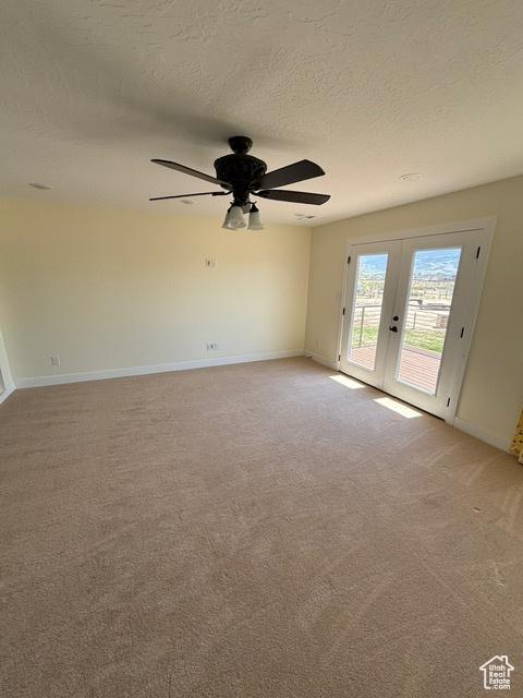 2577 W 5300 N Unit 11, Cedar City, UT 84721 - spare room featuring french doors, a textured ceiling, ceiling fan, light carpet, and baseboards