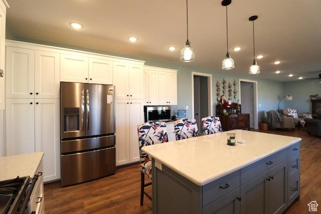 2577 W 5300 N Unit 11, Cedar City, UT 84721 - kitchen featuring appliances with stainless steel finishes, white cabinetry, dark wood finished floors, decorative light fixtures, and open floor plan