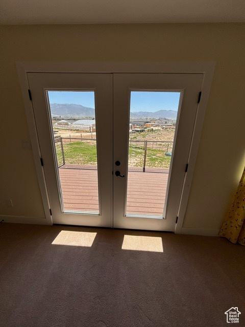 2577 W 5300 N Unit 11, Cedar City, UT 84721 - doorway featuring carpet, french doors, a mountain view, and baseboards