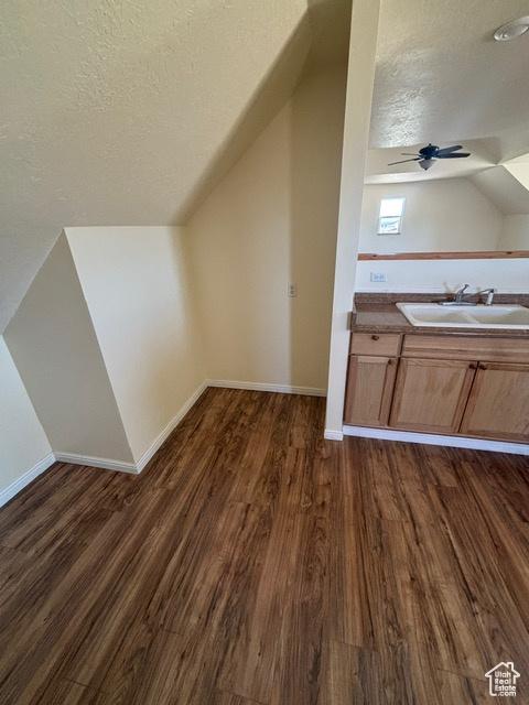 2577 W 5300 N Unit 11, Cedar City, UT 84721 - bonus room featuring a sink, lofted ceiling, a textured ceiling, dark wood-style flooring, and a ceiling fan