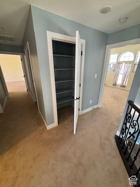 2577 W 5300 N Unit 11, Cedar City, UT 84721 - hall featuring light colored carpet, baseboards, and a textured ceiling