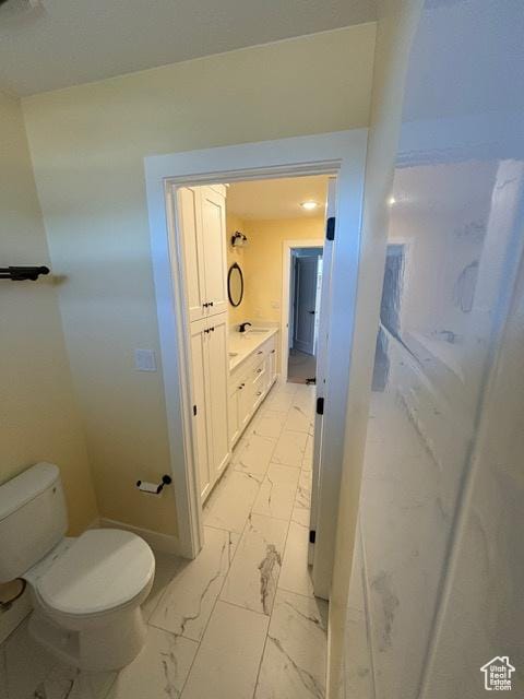 2577 W 5300 N Unit 11, Cedar City, UT 84721 - bathroom featuring toilet, marble look tile flooring, and baseboards