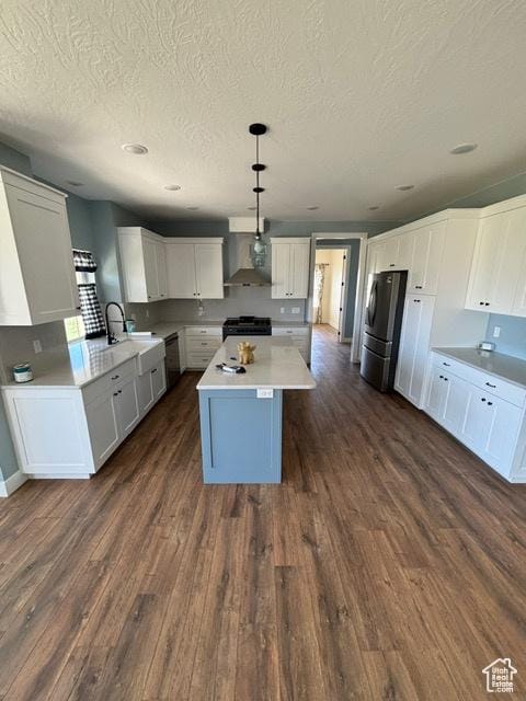 2577 W 5300 N Unit 11, Cedar City, UT 84721 - kitchen with black appliances, a textured ceiling, wall chimney exhaust hood, dark wood-style flooring, and a sink