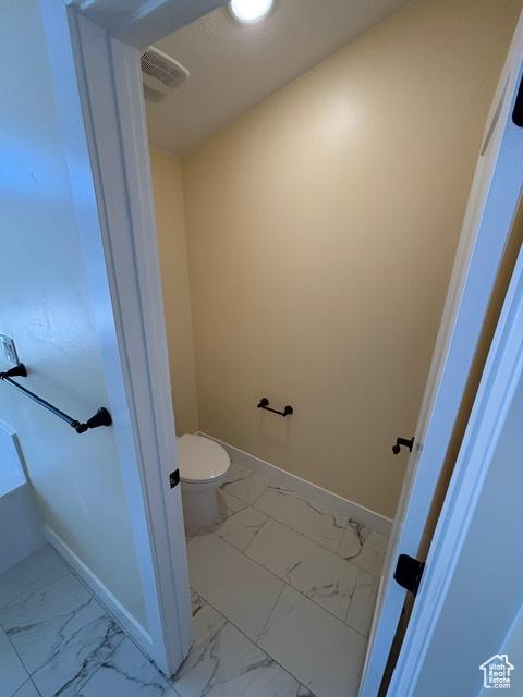 2577 W 5300 N Unit 11, Cedar City, UT 84721 - bathroom with marble finish flooring, toilet, and baseboards