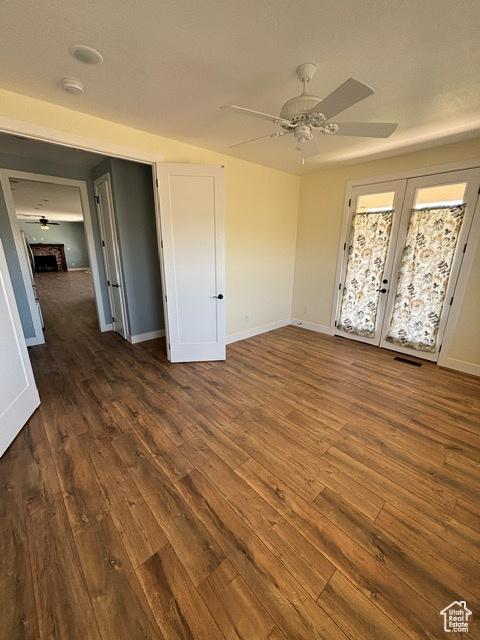 2577 W 5300 N Unit 11, Cedar City, UT 84721 - unfurnished bedroom featuring dark wood-style floors, baseboards, a ceiling fan, and french doors