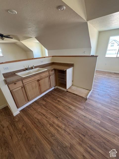 2577 W 5300 N Unit 11, Cedar City, UT 84721 - kitchen featuring a textured ceiling, a sink, dark wood-type flooring, baseboards, and light brown cabinets