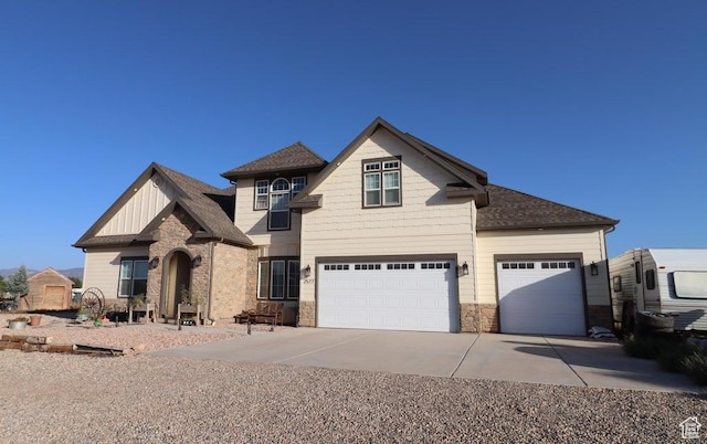 2577 W 5300 N Unit 11, Cedar City, UT 84721 - craftsman-style home with stone siding, concrete driveway, board and batten siding, a garage, and a shingled roof