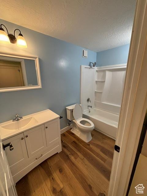 2577 W 5300 N Unit 11, Cedar City, UT 84721 - full bathroom featuring wood finished floors, toilet, a textured ceiling, shower / bath combination, and vanity
