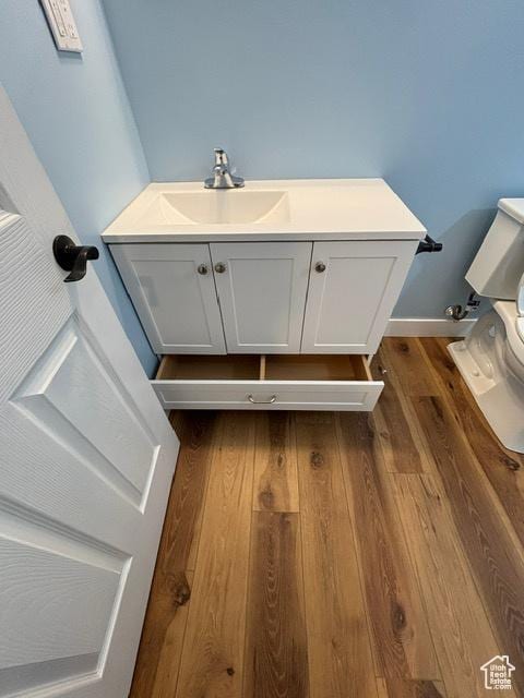 2577 W 5300 N Unit 11, Cedar City, UT 84721 - bathroom with wood finished floors, toilet, and vanity