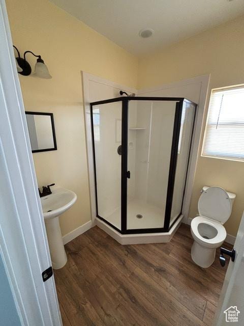 2577 W 5300 N Unit 11, Cedar City, UT 84721 - bathroom featuring a stall shower, wood finished floors, and baseboards