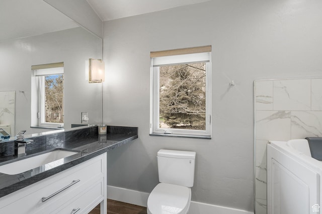 1303 Country Ln, Kamas, UT 84036 - bathroom featuring toilet, wood finished floors, baseboards, vanity, and washer / clothes dryer