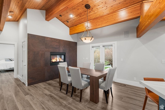 1303 Country Ln, Kamas, UT 84036 - dining area featuring high vaulted ceiling, beam ceiling, a tiled fireplace, visible vents, and dark wood-style flooring
