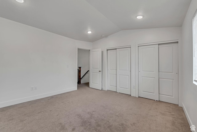 1679 S 1355 E Unit A21, Ogden, UT 84404 - unfurnished bedroom with two closets, carpet floors, lofted ceiling, baseboards, and recessed lighting
