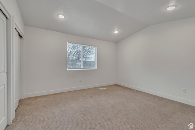 1679 S 1355 E Unit A21, Ogden, UT 84404 - unfurnished bedroom with light colored carpet, vaulted ceiling, baseboards, recessed lighting, and a closet