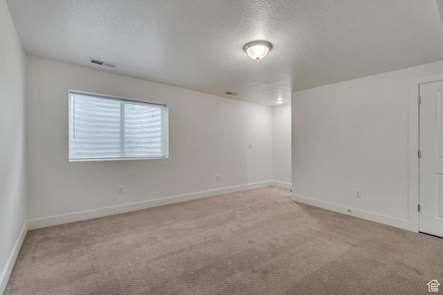 1679 S 1355 E Unit A21, Ogden, UT 84404 - unfurnished room featuring light carpet, a textured ceiling, and baseboards