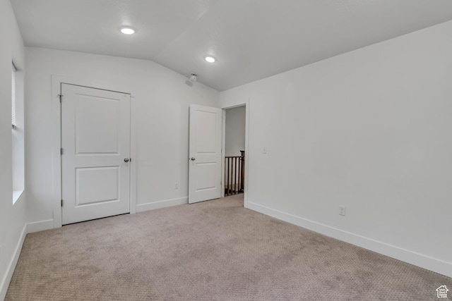 1679 S 1355 E Unit A21, Ogden, UT 84404 - unfurnished bedroom featuring light carpet, baseboards, and lofted ceiling