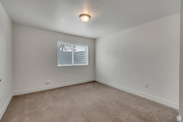 1679 S 1355 E Unit A21, Ogden, UT 84404 - unfurnished room with light carpet, baseboards, and a textured ceiling