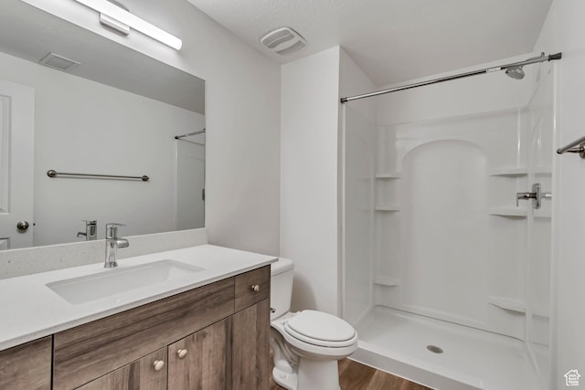 1679 S 1355 E Unit A21, Ogden, UT 84404 - bathroom with vanity, a shower, toilet, and wood finished floors
