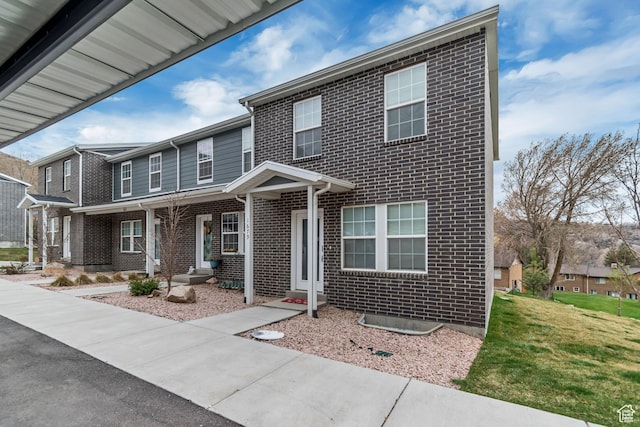 1679 S 1355 E Unit A21, Ogden, UT 84404 - view of front of house featuring brick siding and a front yard