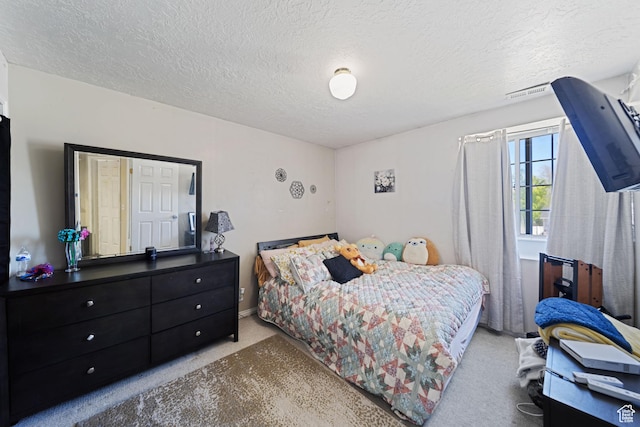 carpeted bedroom featuring a textured ceiling