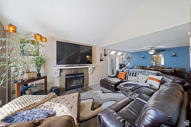 carpeted living room featuring a tile fireplace and baseboards