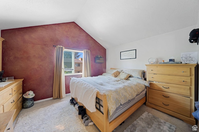 carpeted bedroom with vaulted ceiling