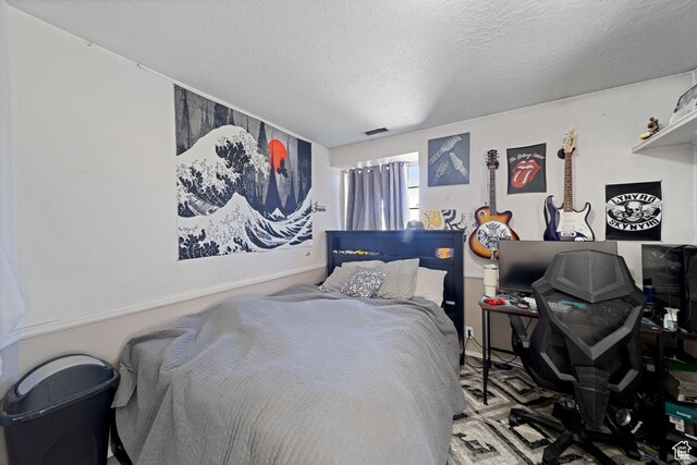 carpeted bedroom with a textured ceiling