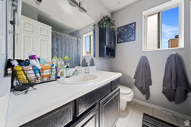 bathroom featuring toilet, vanity, baseboards, and curtained shower
