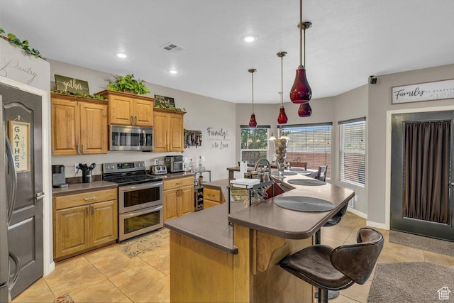 3322 W Bonita, Hurricane, UT 84737 - kitchen with dark countertops, appliances with stainless steel finishes, and light tile patterned flooring