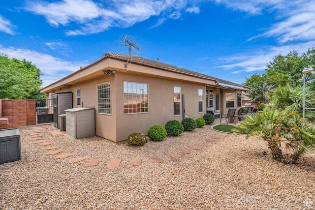 3322 W Bonita, Hurricane, UT 84737 - view of home's exterior with a patio area, cooling unit, stucco siding, and a gate