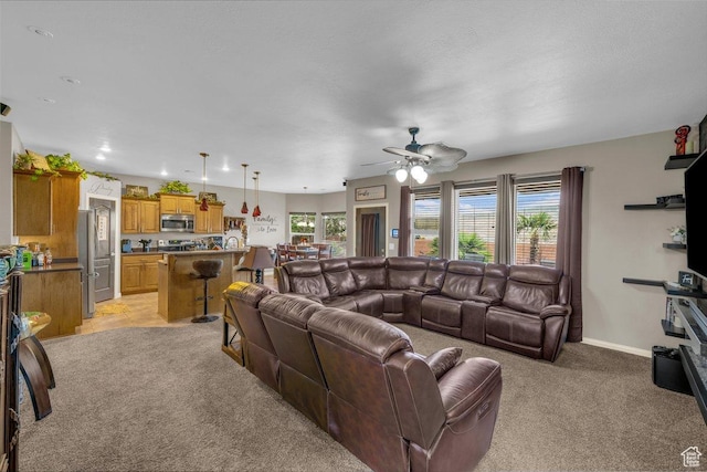 3322 W Bonita, Hurricane, UT 84737 - living room featuring baseboards, a wealth of natural light, ceiling fan, and light colored carpet