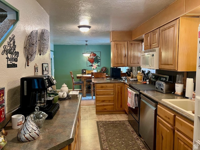 kitchen featuring a textured ceiling, white microwave, range, and stainless steel dishwasher