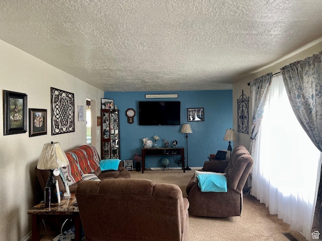 living room with light colored carpet, a textured ceiling, visible vents, and baseboards