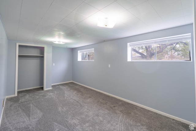 unfurnished bedroom with a closet, baseboards, and carpet floors