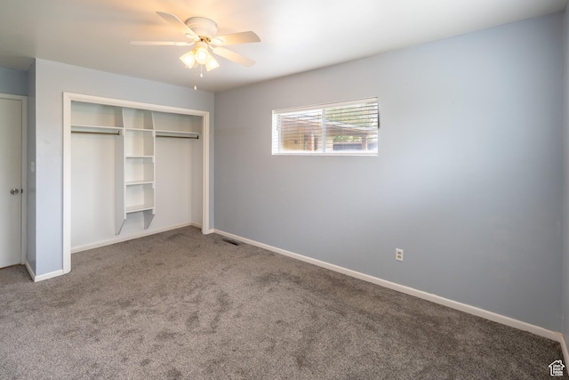 unfurnished bedroom with a closet, baseboards, ceiling fan, visible vents, and carpet floors