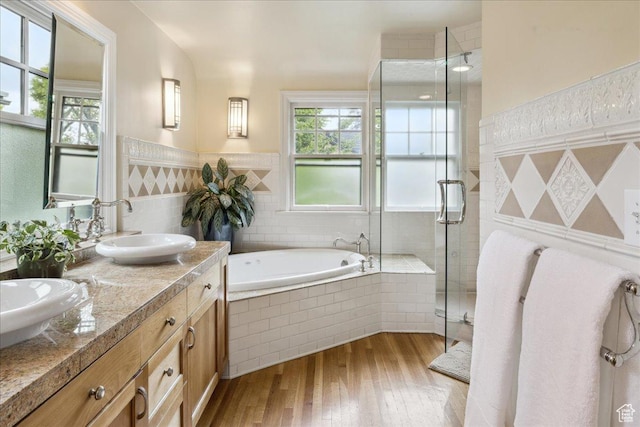 1704 E Herbert Ave, Salt Lake City, UT 84108 - bathroom featuring a sink, a garden tub, plenty of natural light, and wood finished floors