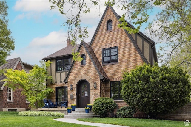 1704 E Herbert Ave, Salt Lake City, UT 84108 - english style home with a front lawn, a shingled roof, brick siding, and a chimney
