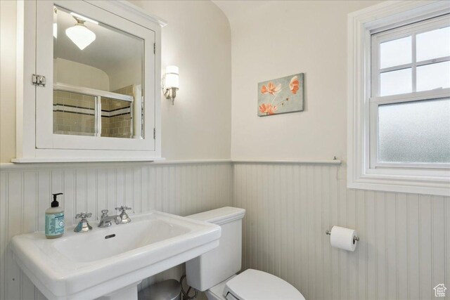 1704 E Herbert Ave, Salt Lake City, UT 84108 - bathroom featuring wainscoting, a stall shower, toilet, and a sink